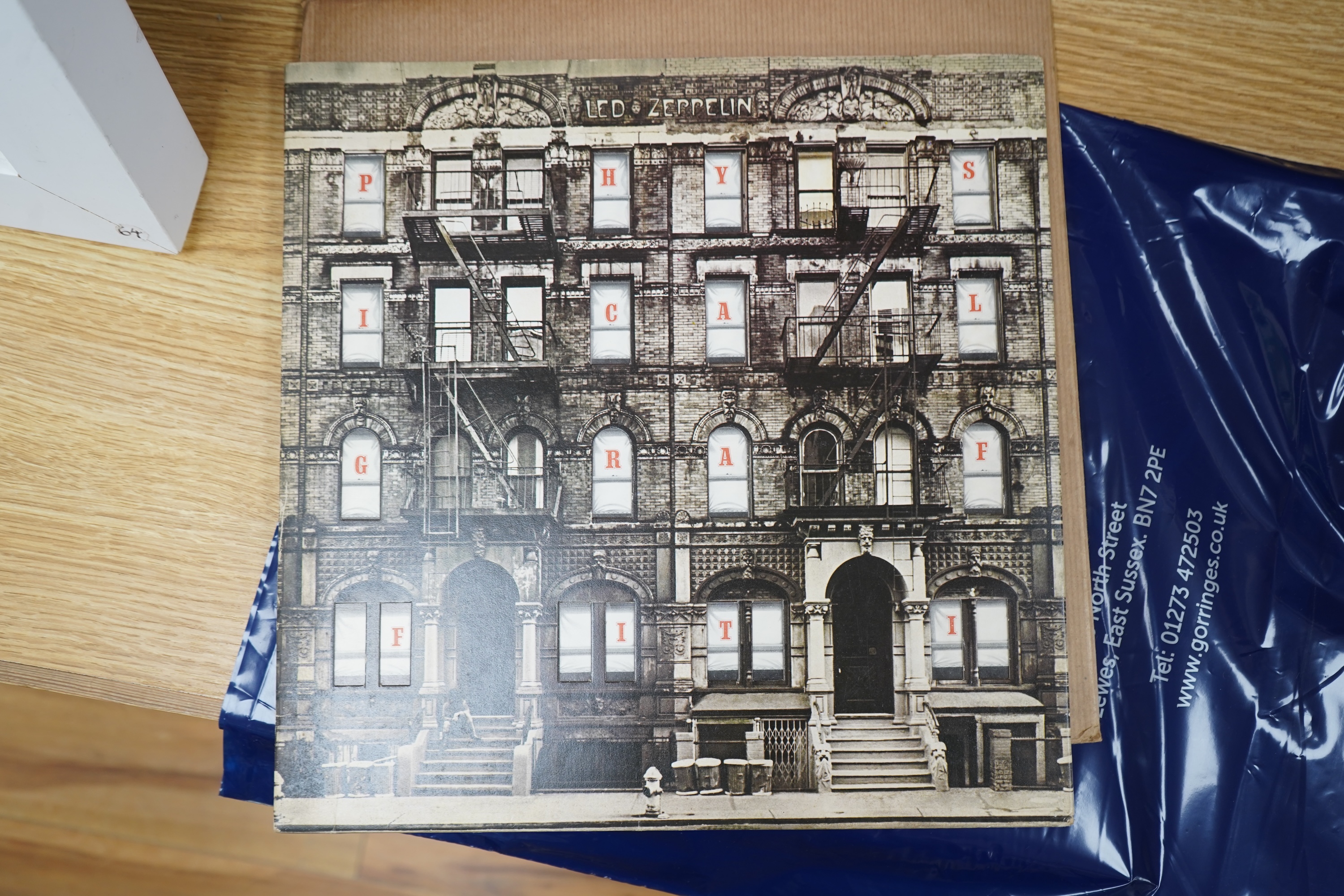 Five Led Zeppelin LP record albums; In Through the Out Door (SSK59410), Physical Graffiti (SSK89400), Presence (SSK59402), Houses of the Holy (K50014), and The Soundtrack from the Film The Song Remains the Same (SSK89402